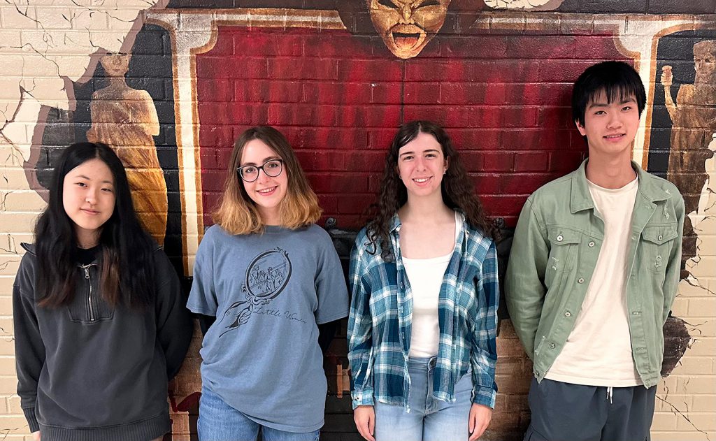 Four students smiling for a photo.