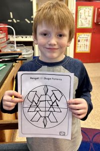 Student is holding a piece of paper with shape patterns on it