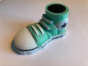 Close up image of 3D printed green shoe designed by student
