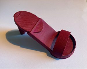 Close up image of 3D printed red shoe designed by student