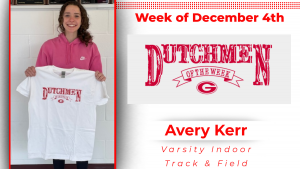 Student standing in front of a white wall, holding a white t-shirt with red lettering that reads: Dutchmen of the Week