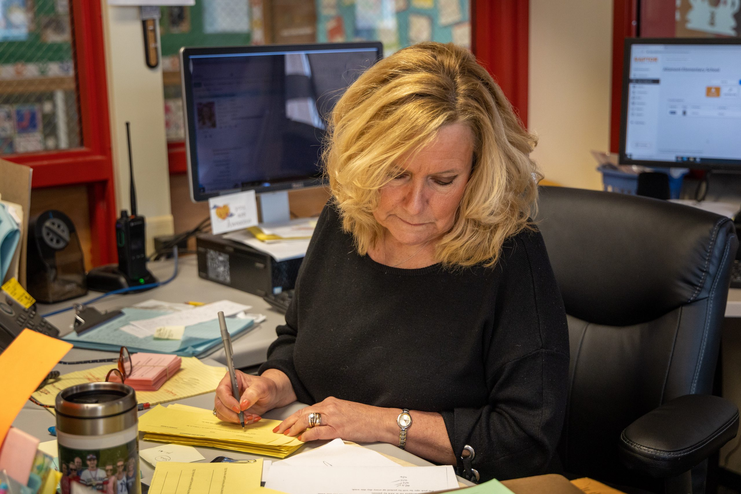 An employee works on paperwork sitting at a desk