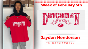 A student stands holding a red t-shirt with white lettering that reads: Dutchmen of the Week