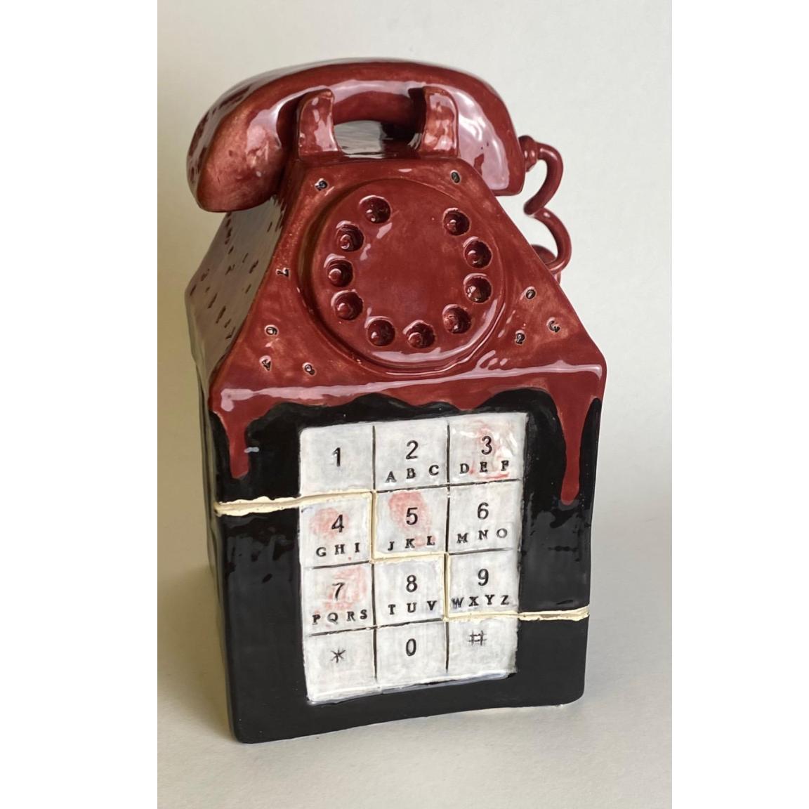 Student artwork, a sculpture of a red phone on top of a box with a keypad on the face of the box