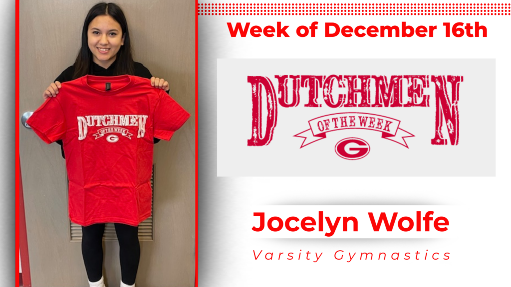 student smiling and holding up Dutchmen of the Week tshirt.