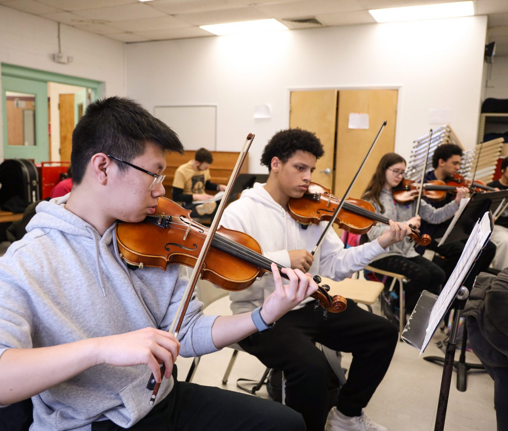GHS orchestra students practicing their instruments in class.