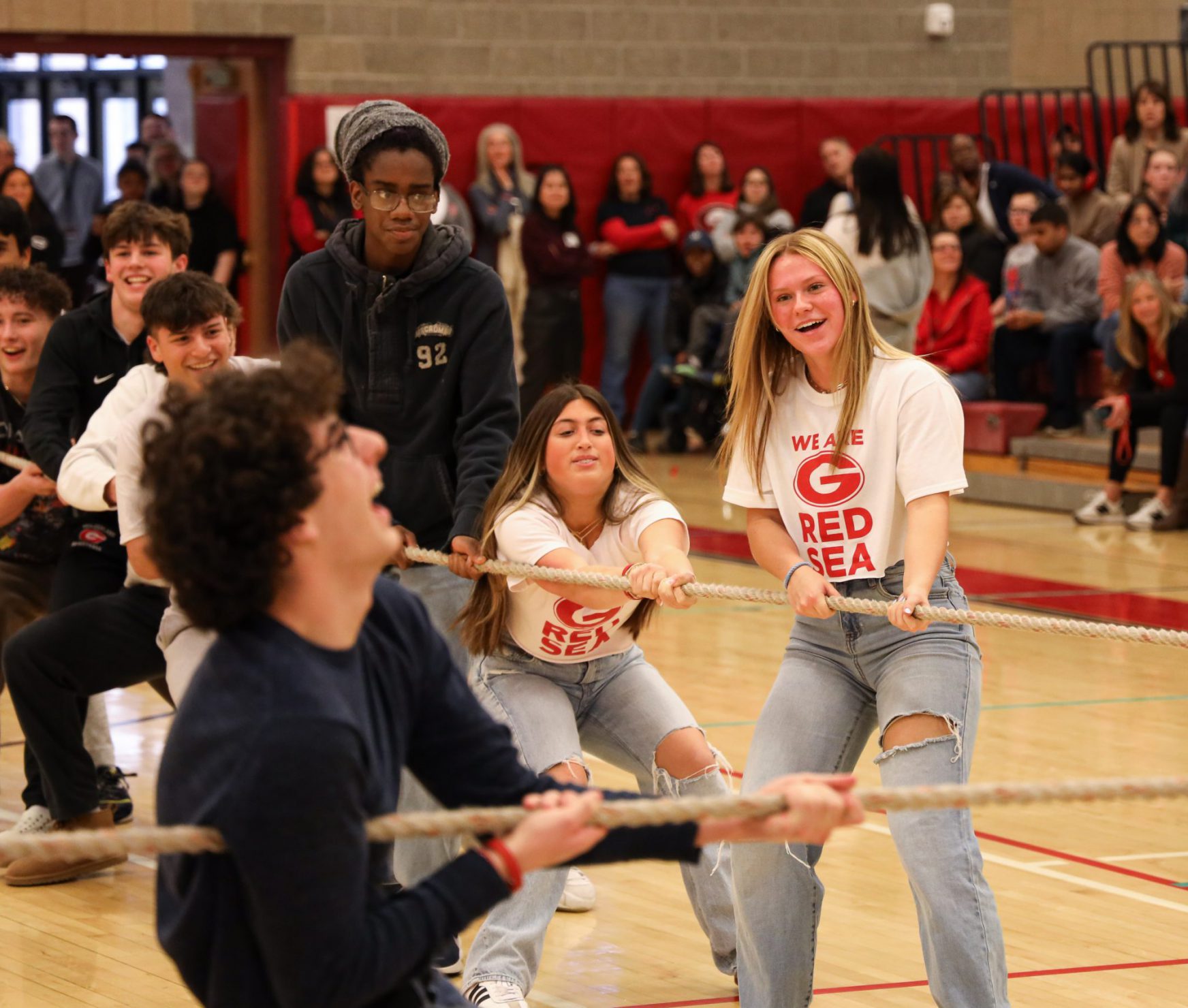 GHS students playing tug of war at the spirit rally. They are laughing.