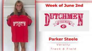 A student is smiling, displaying a red T-shirt with white lettering that reads: Dutchmen of the Week