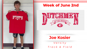 A student is smiling, displaying a red T-shirt with white lettering that reads: Dutchmen of the Week