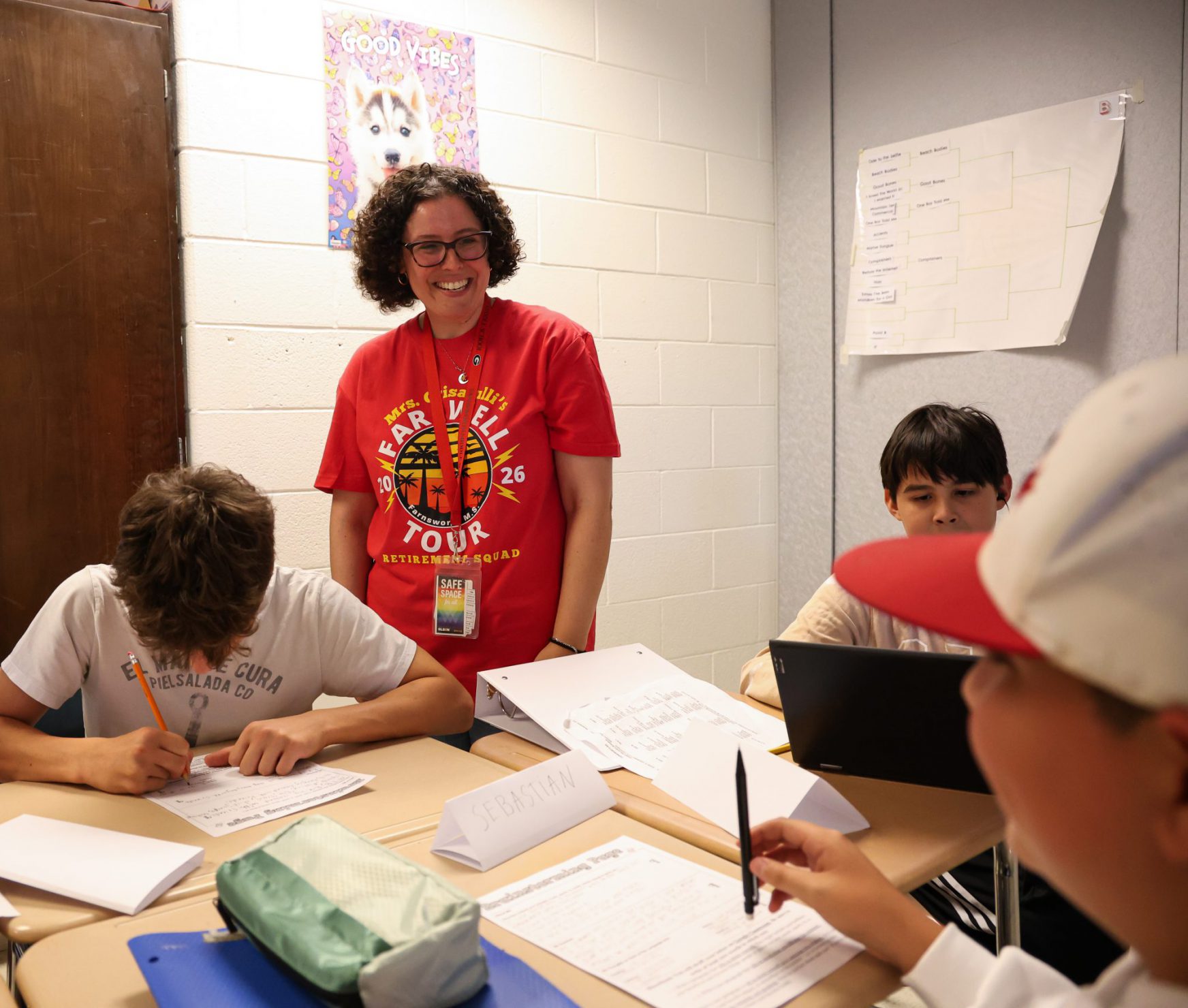 FMS teacher and students smiling in class.