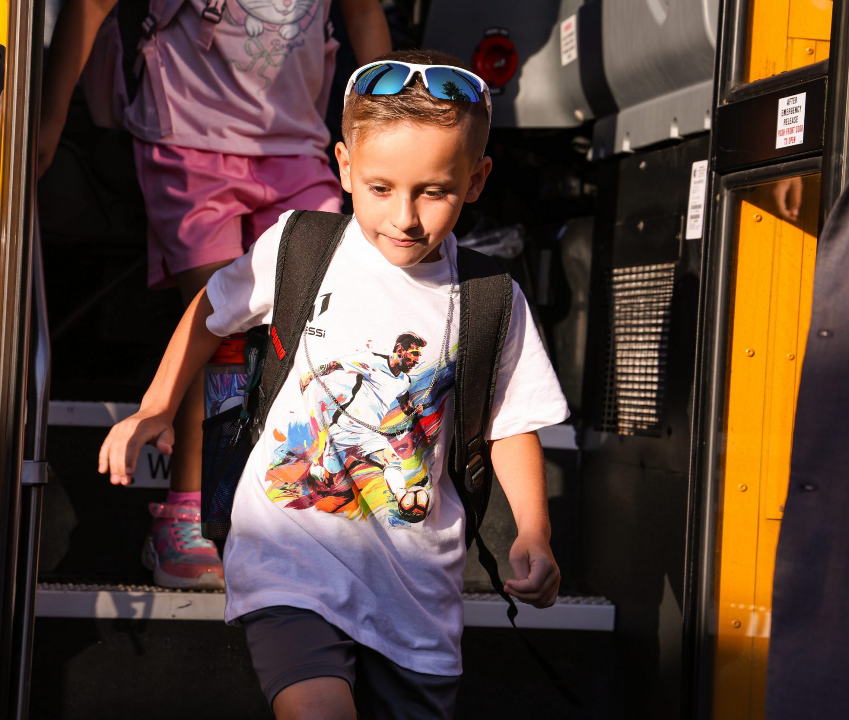 Student coming off bus in the morning.