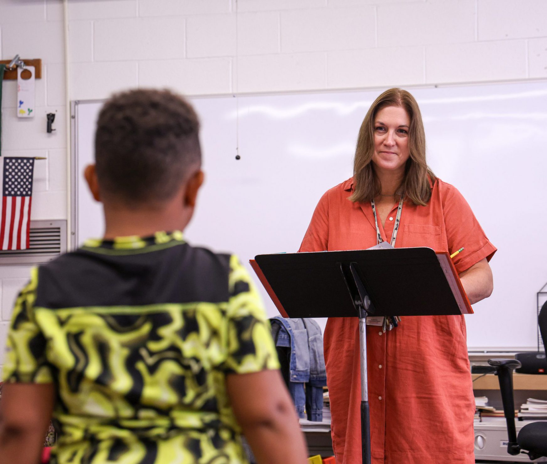 Music teacher smiling at student.