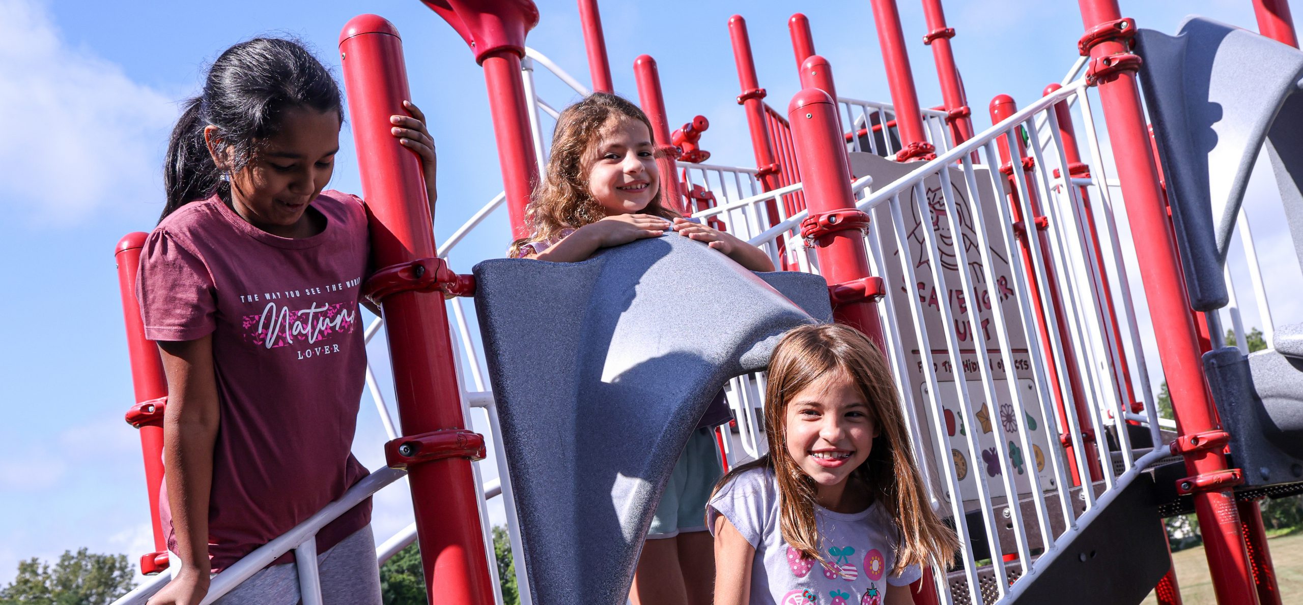 Elementary students smiling on the playground.