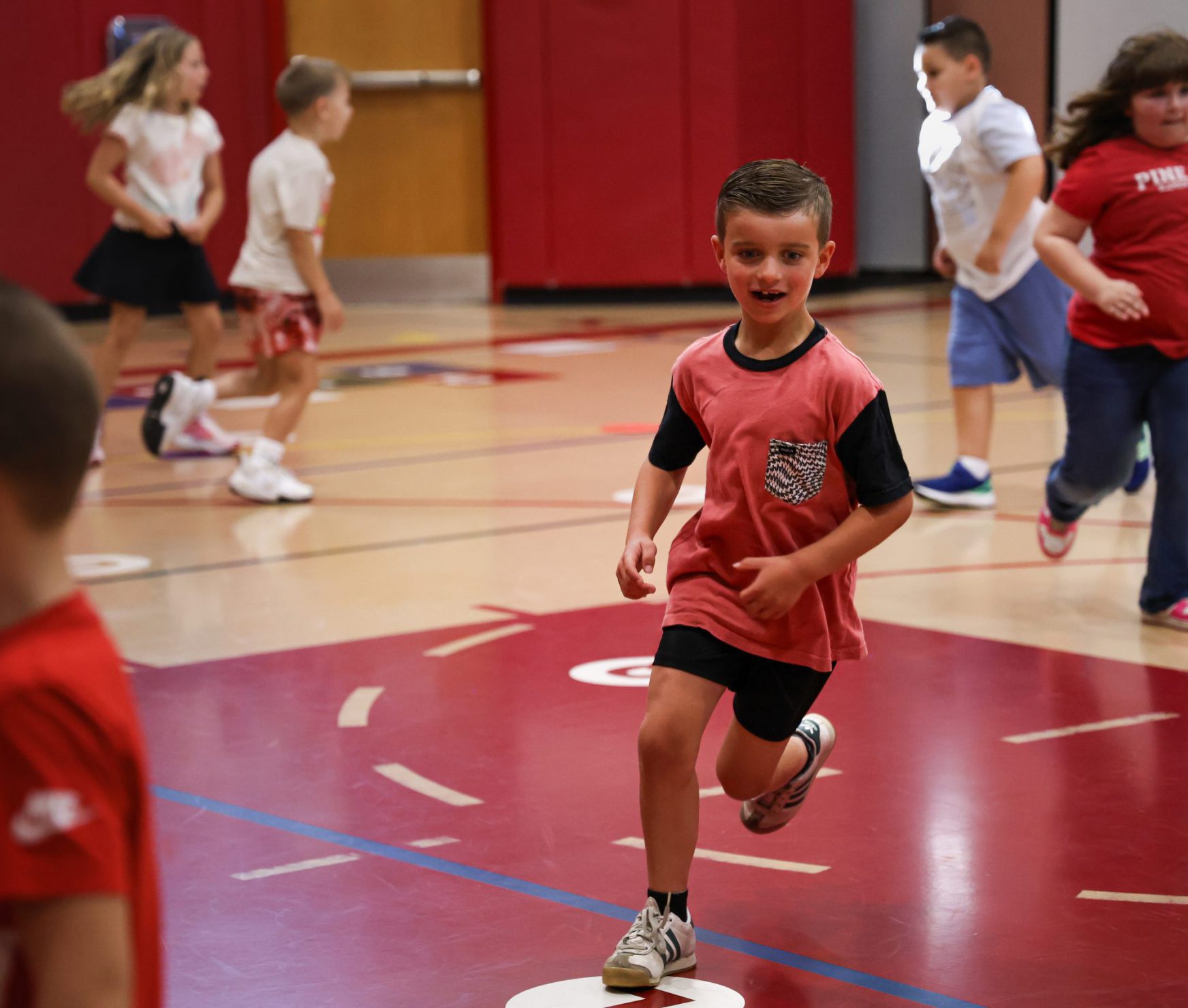 PBES student running in gym class.