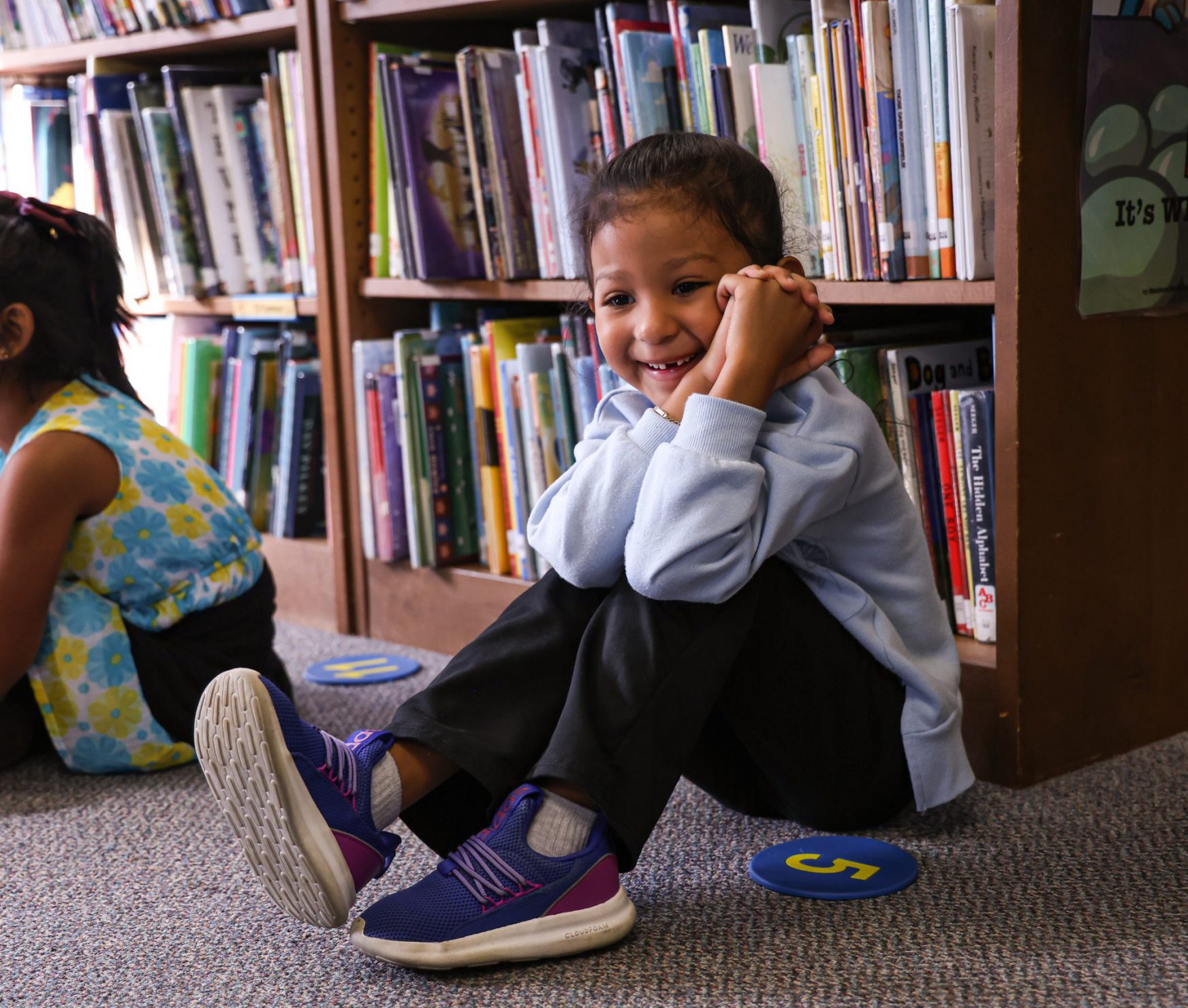 AES student smiling in library.
