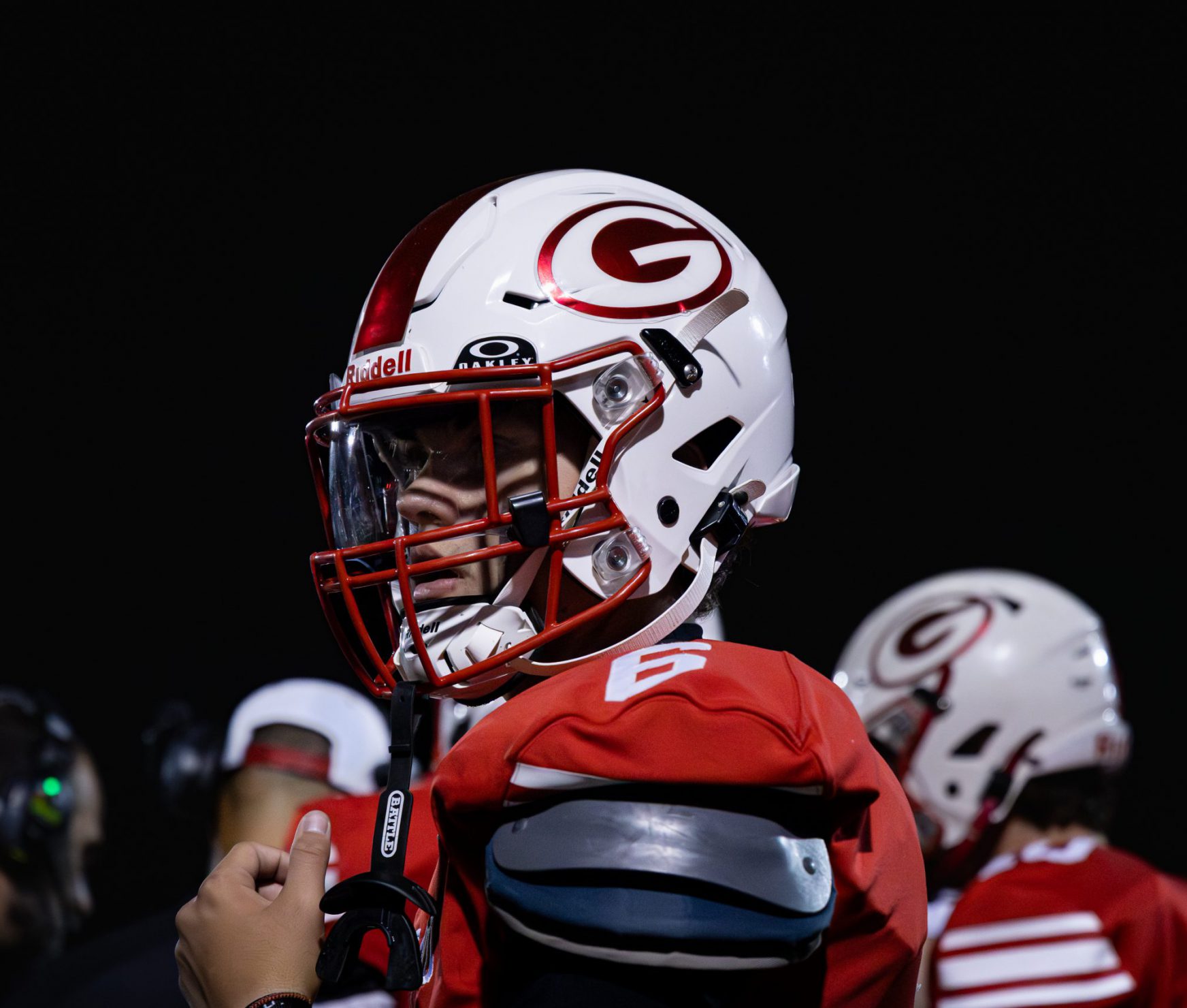 GHS Dutchman football player in uniform at homecoming game. He is looking at the field.