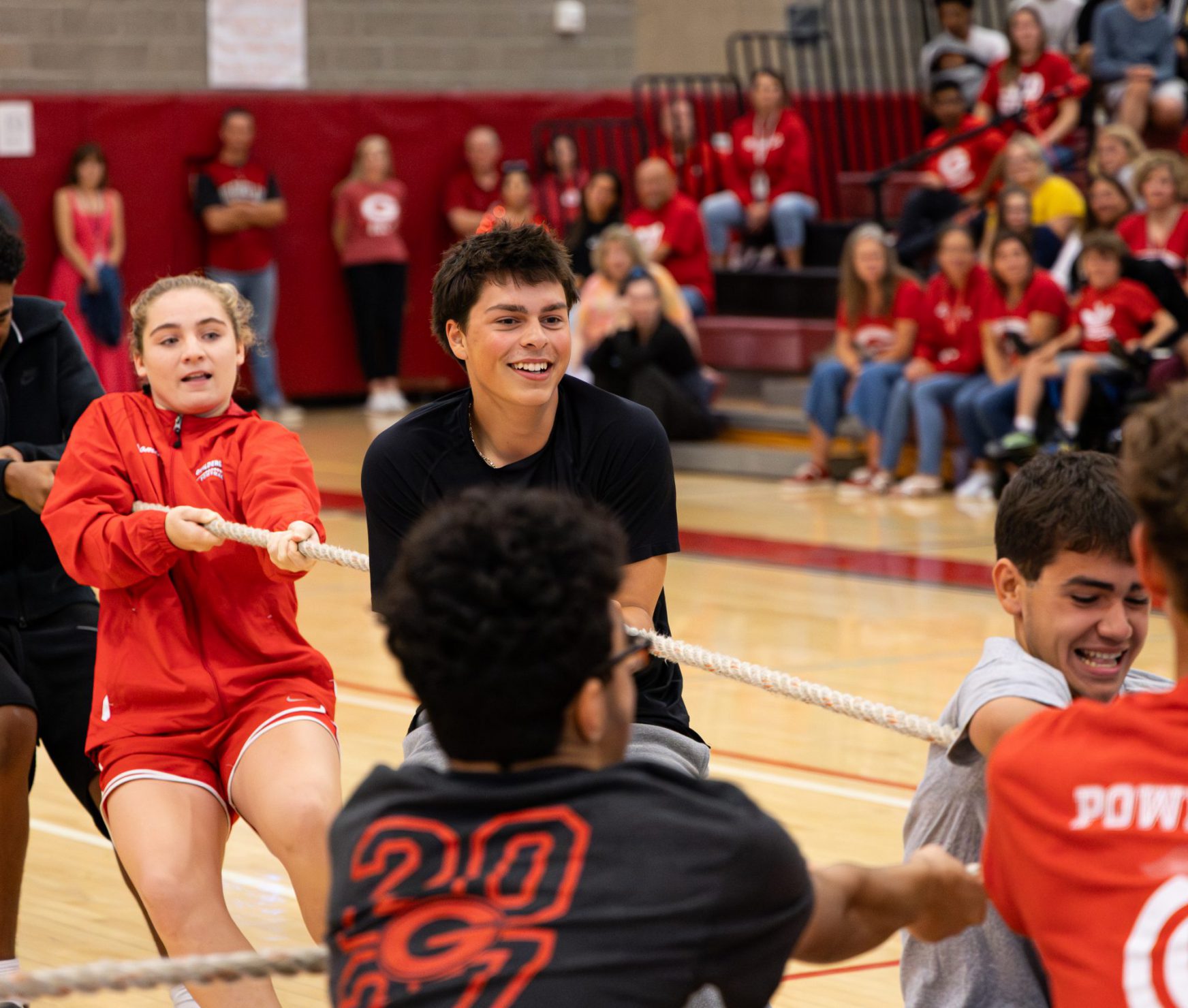 GHS students playing tug of war at spirit rally. They are smiling.