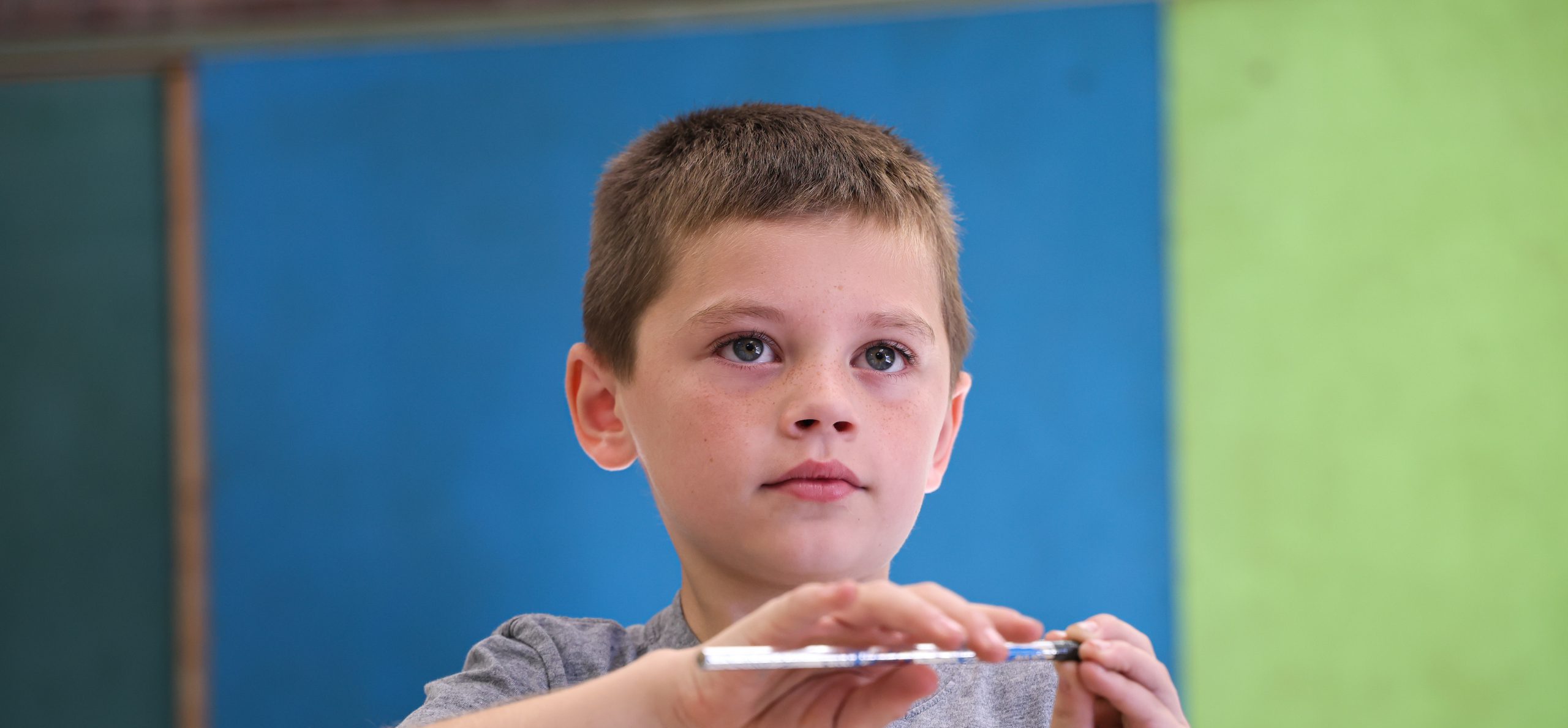 AES student focusing in class while holding a pencil.