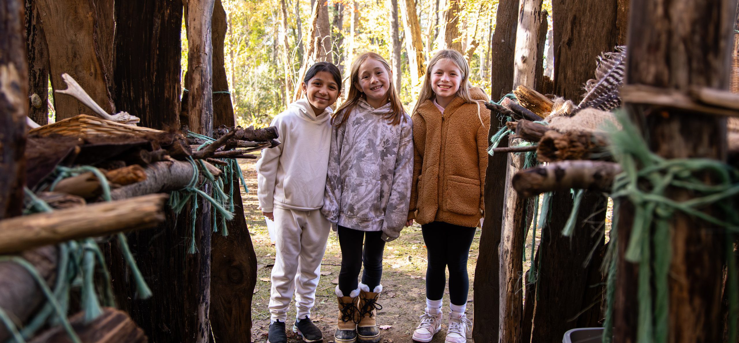 LES students smiling in longhouse.