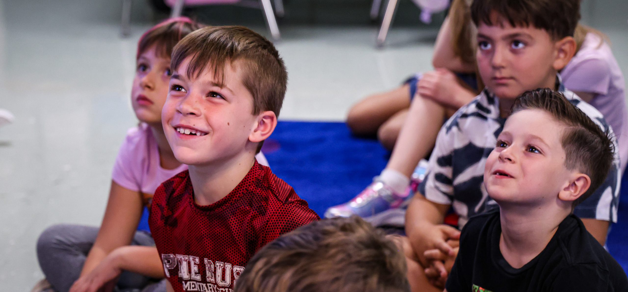PBES students smiling in class.