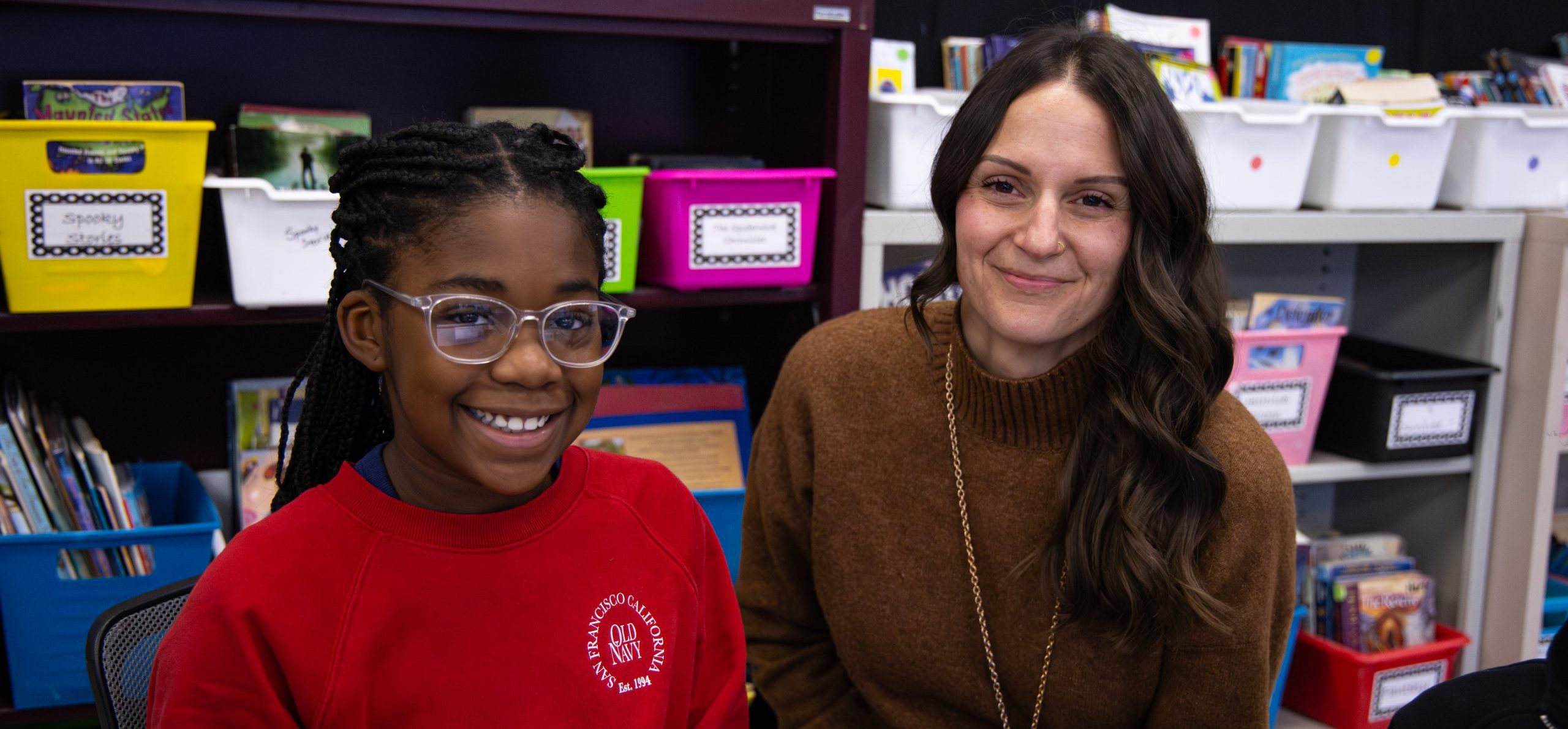 Elementary students smiling on the playground.
