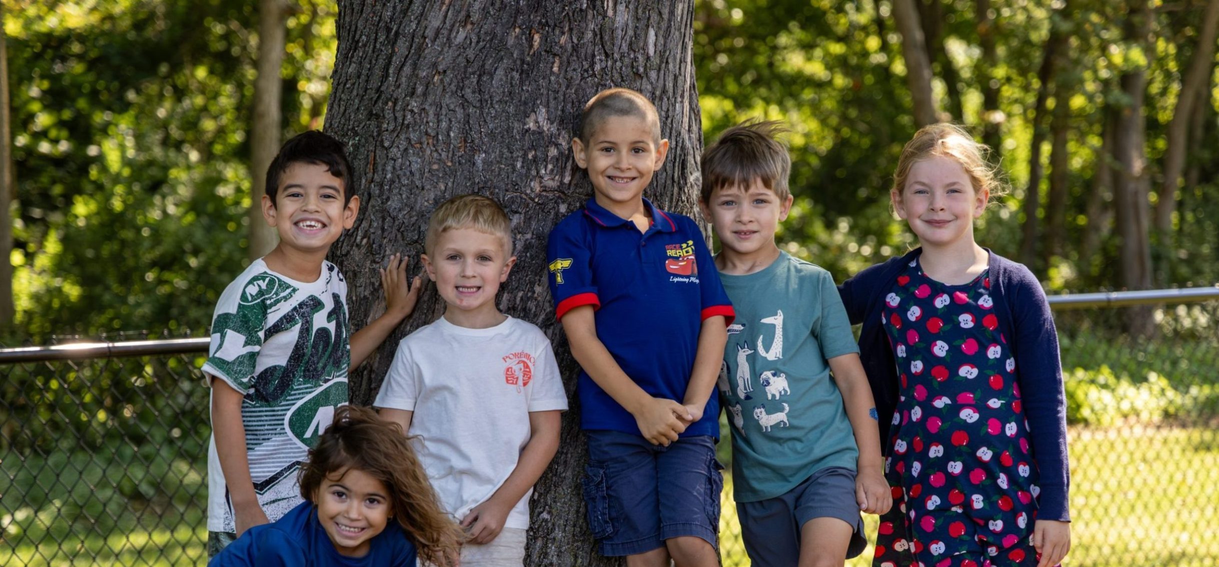 Elementary students smiling on the playground.